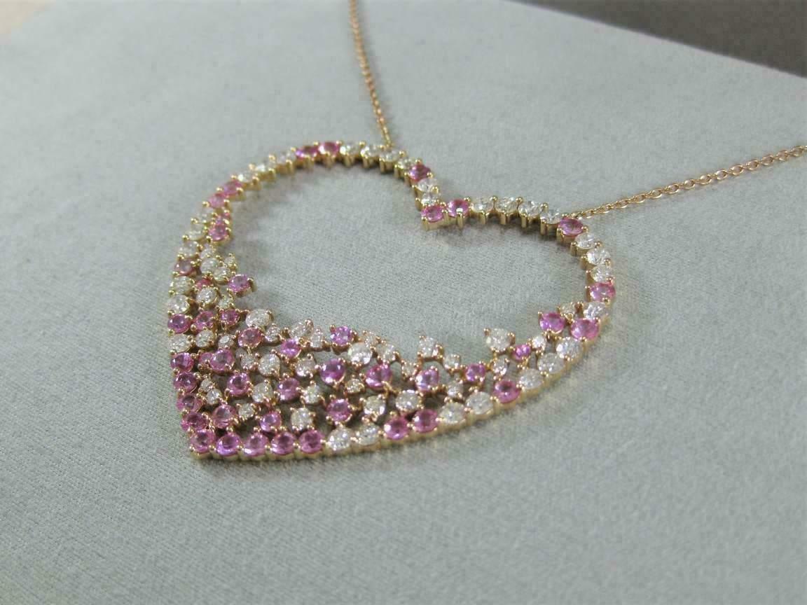 Elegant 925 sterling silver heart pendant featuring a fuchsia pink cubic zirconia center.