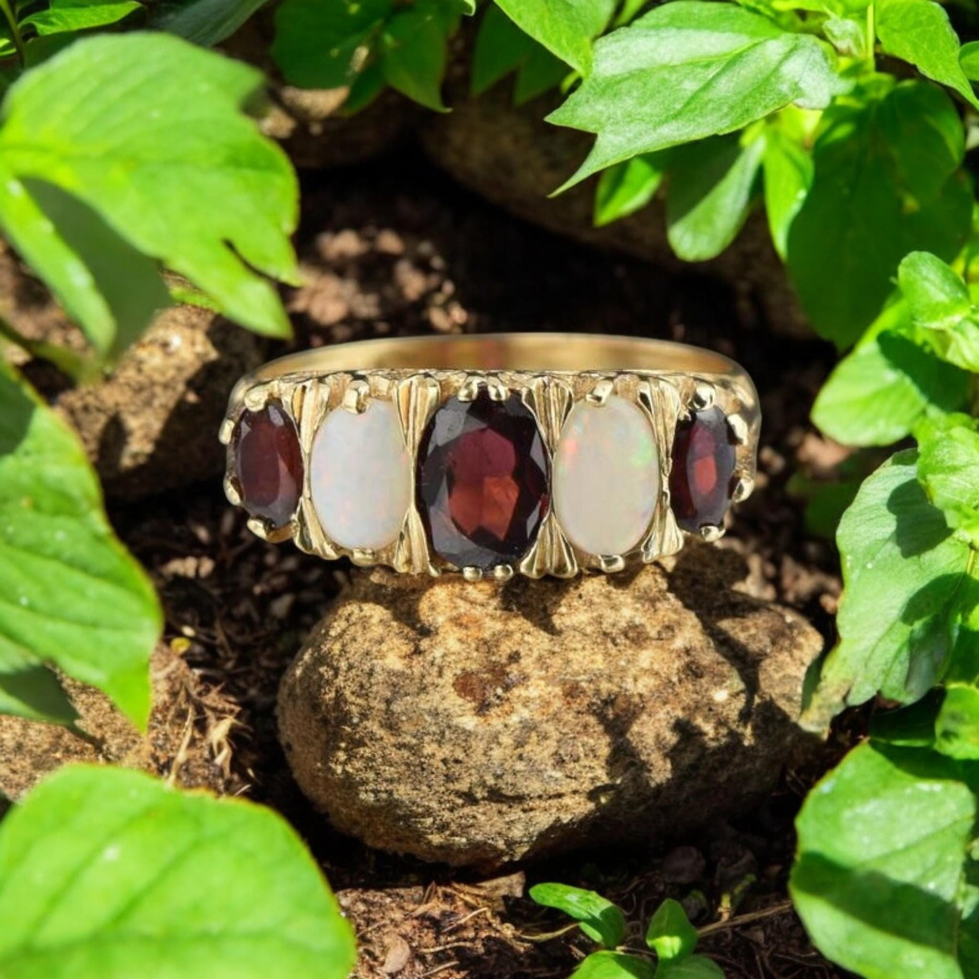 Unisex statement ring featuring natural garnet and opal in a classic Edwardian-inspired gold-plated setting.