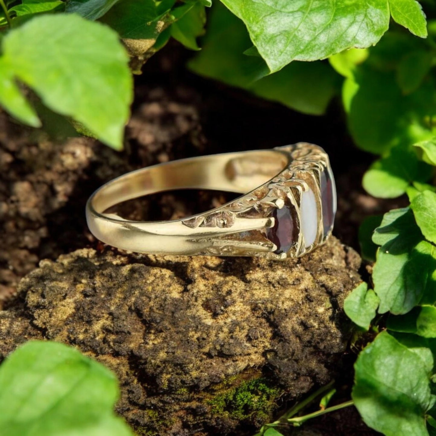 Unique red garnet and opal gemstone ring, perfect for vintage jewelry lovers.