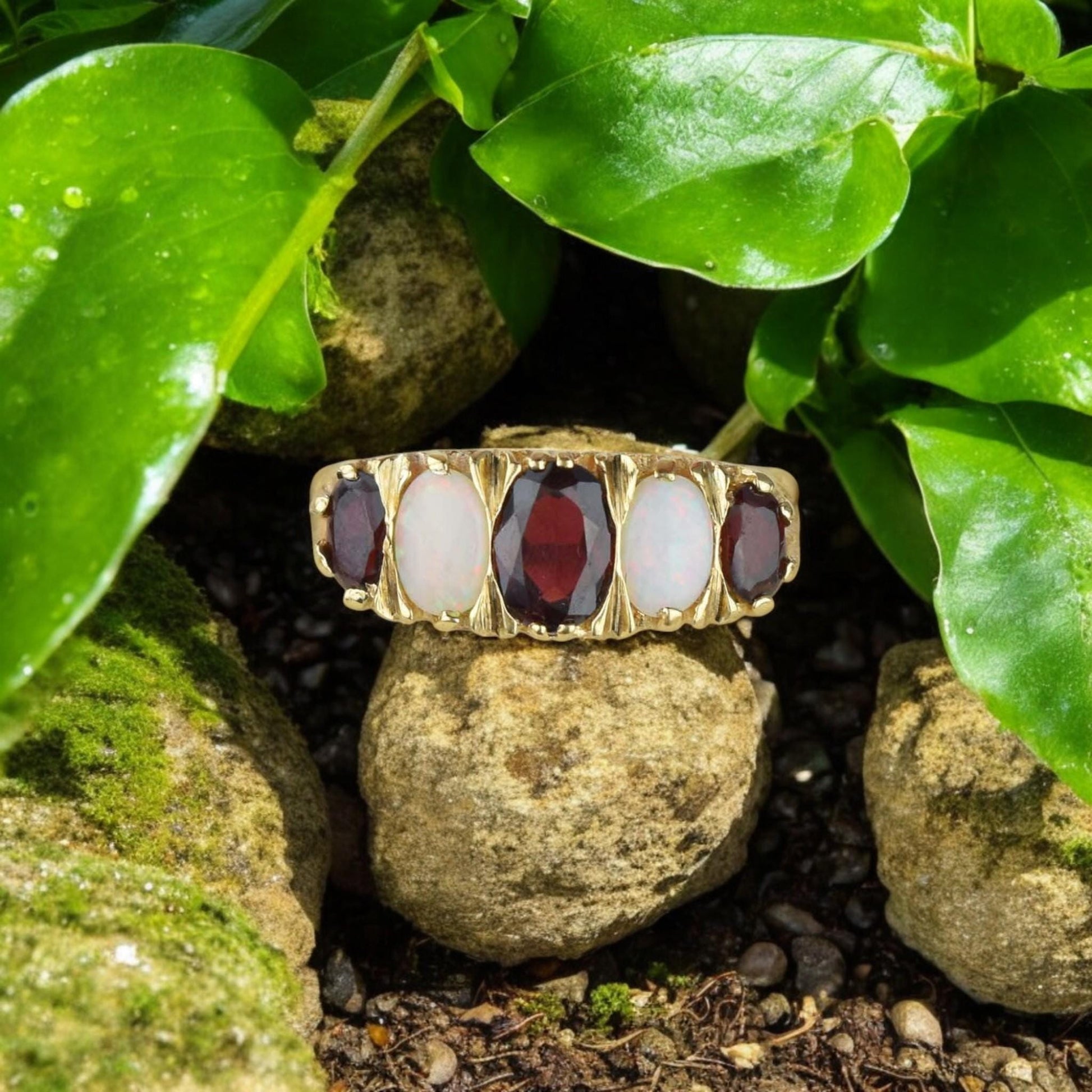 Vintage-inspired unisex ring featuring an oval-cut red garnet and opal in a gold-plated silver setting.