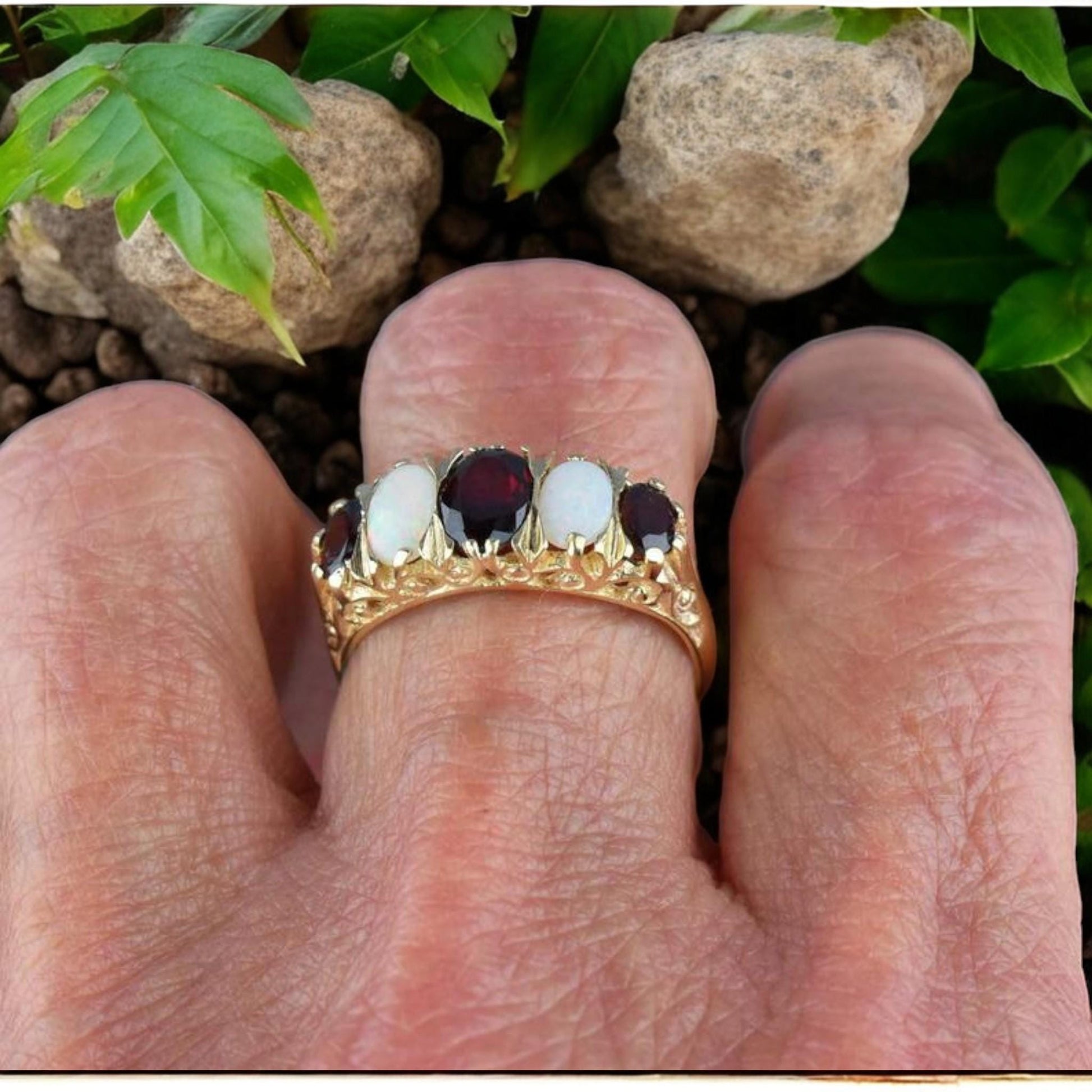 Handmade antique-style garnet and opal ring with intricate gold-plated silver detailing.
